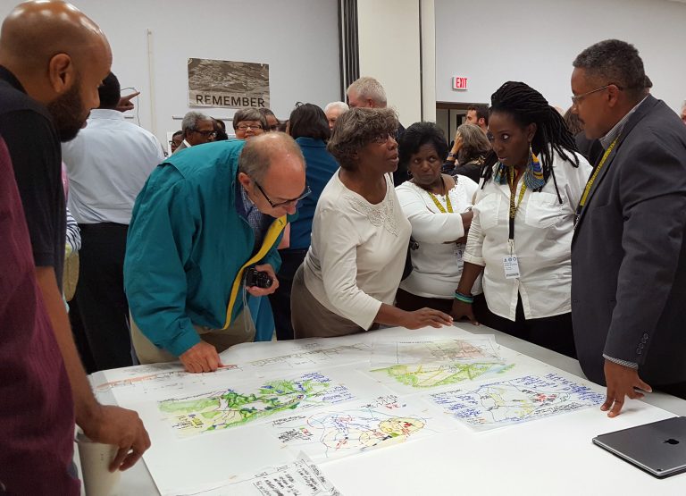 Design Team member Kofi Boone, far right, and Princeville, N.C., Mayor Pro Tem Linda Joyner, second from right, discuss plans for a proposed expansion of Princeville, N.C., with residents.